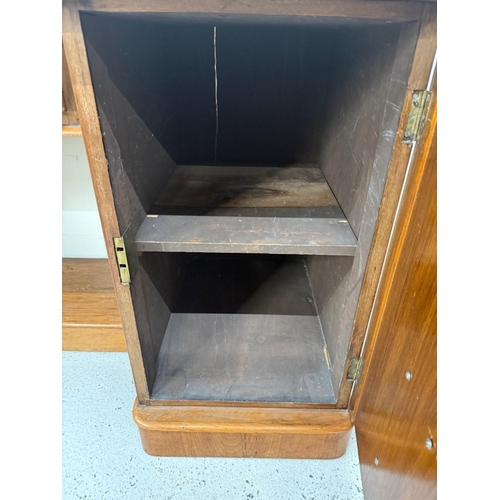 84 - A mahogany knee hole desk with a central drawer and flanked by faux drawers and cupboards