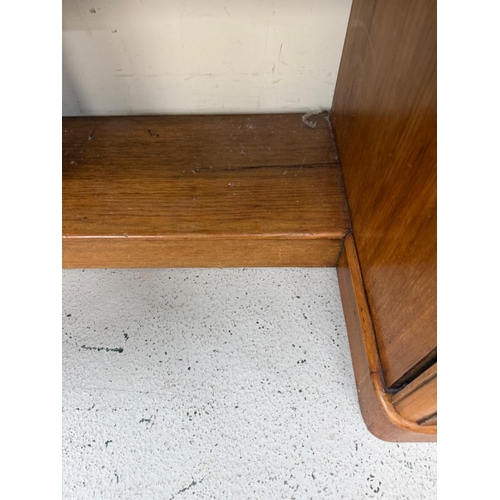 84 - A mahogany knee hole desk with a central drawer and flanked by faux drawers and cupboards
