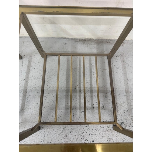 85 - A pair of modern Regency brass and smoked glass side tables H41cm W52cm D52cm