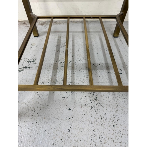 85 - A pair of modern Regency brass and smoked glass side tables H41cm W52cm D52cm