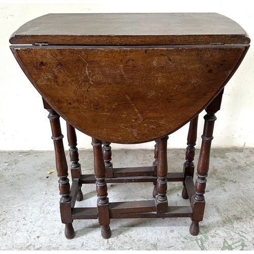 91 - An oak drop leaf table on turned legs H75cm W60cm D38cm