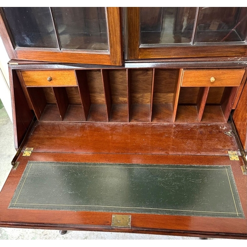 93 - A glazed mahogany bureau bookcase above a sloped writing desk with graduated drawers H206cm W90cm D4... 