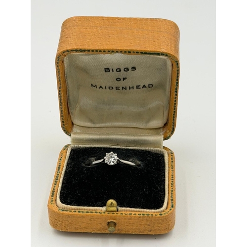571 - A platinum diamond ring approximate weight 2.1g and size N by Biggs of Maidenhead.