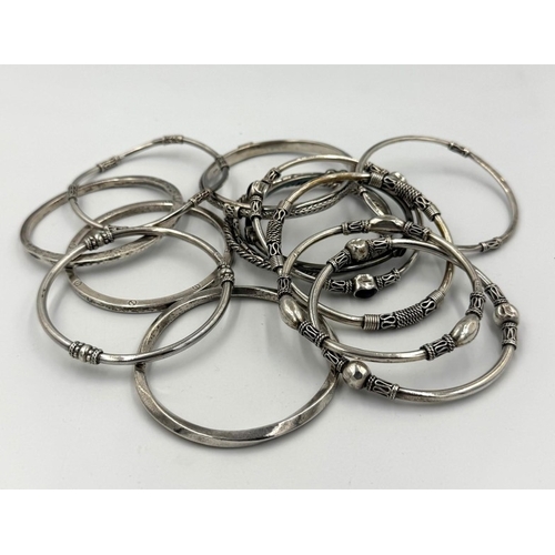 572 - A selection of silver bangles, various hallmarks and designs, approximate combined weight 265g