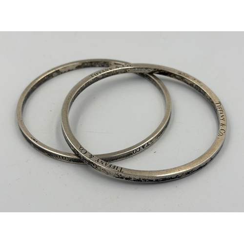 573 - Two silver bangles, marked for Tiffany and Co