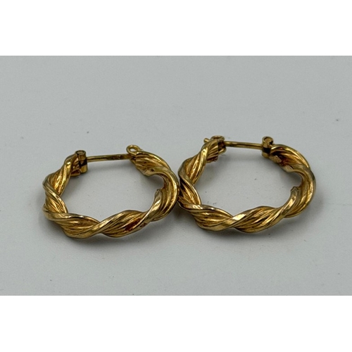 585 - A pair of 9ct gold twisted hoop earrings with an approximate weight of 2g