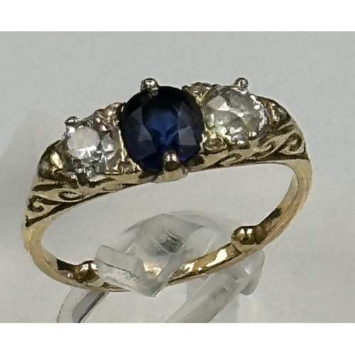 592 - A Sapphire ring with diamonds either size, on an 18ct gold setting, size K