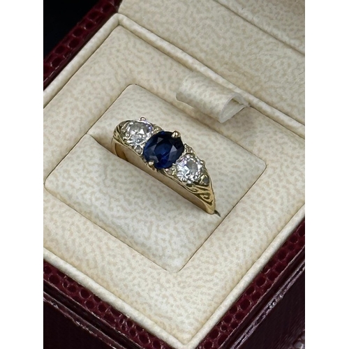 592 - A Sapphire ring with diamonds either size, on an 18ct gold setting, size K
