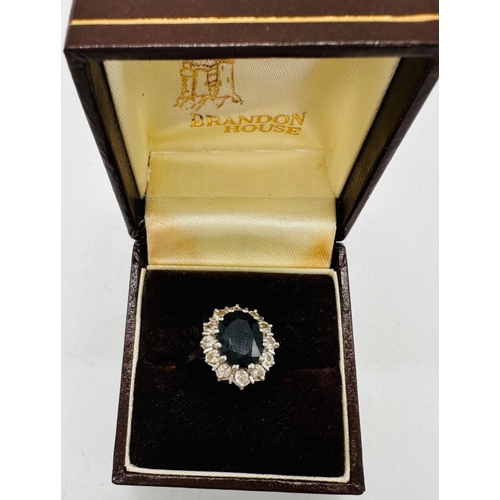 594 - An 18ct gold set sapphire and diamond cluster ring, approximate weight 5.8g and size L