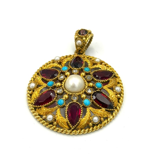 597 - A fabulous multi gem stone circular pendant with an approximate weight of 24g, 45mm diameter, set wi... 