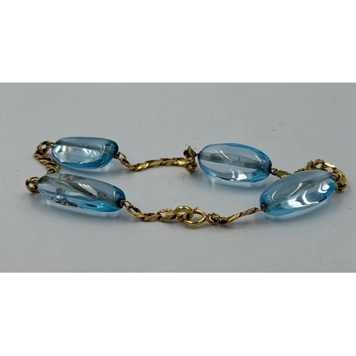 605 - A four blue stone gold bracelet, marked 750, approximate total weight 10.2g