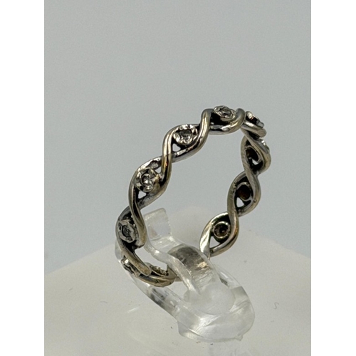607 - A diamond eternity style white gold ring, not hallmarked, approximate weight 2.3g and size N