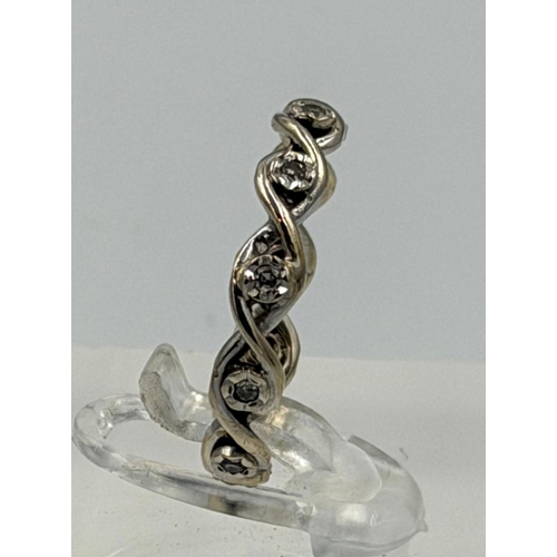 607 - A diamond eternity style white gold ring, not hallmarked, approximate weight 2.3g and size N