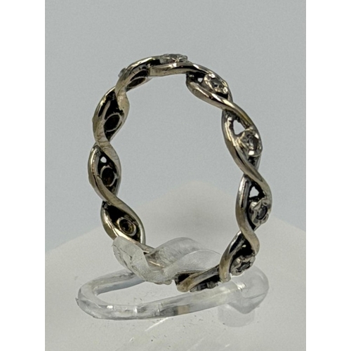 607 - A diamond eternity style white gold ring, not hallmarked, approximate weight 2.3g and size N