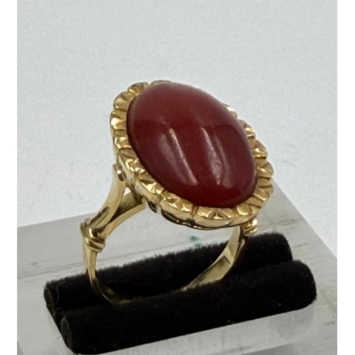 609 - An 18ct coral gold ring, approximate weight 8.9g and size L.