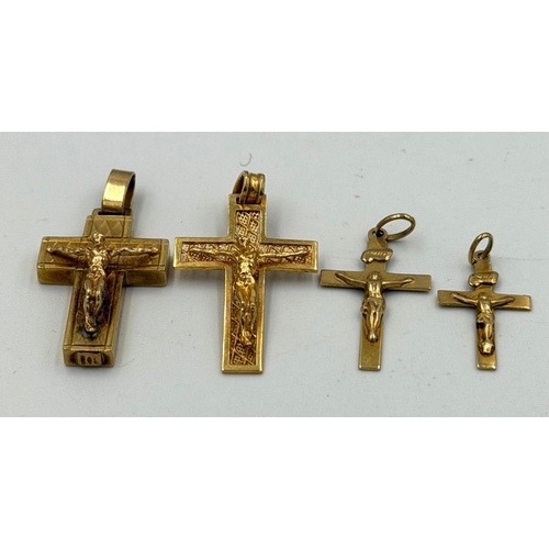610 - A selection of four differing 9ct yellow gold crucifix pendants with an approximate weight of 9.3g