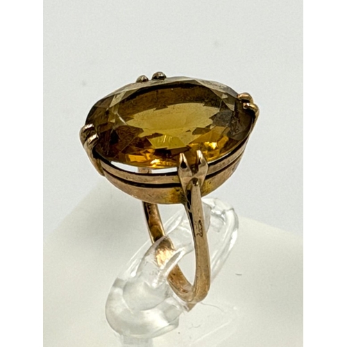 611 - A 9ct yellow gold set citrine, cocktail style ring approximate weight 5.8g and size P.