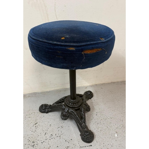 A black painted cast iron piano stool with blue velvet seat.
