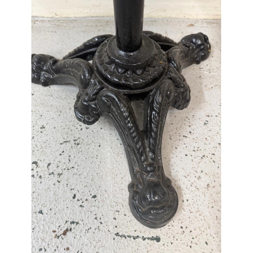 A black painted cast iron piano stool with blue velvet seat.