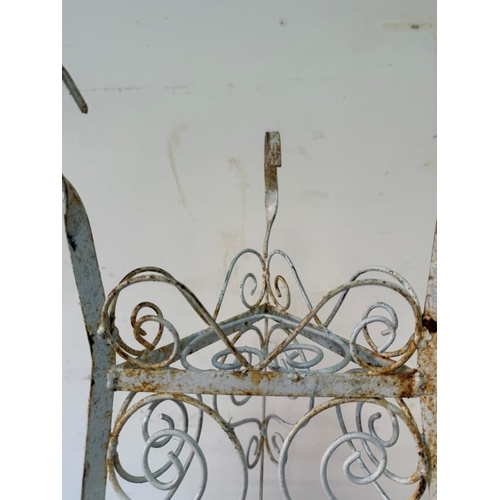 A white painted wrought-iron three tier corner plant stand