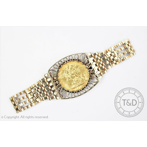 113 - A George V gold sovereign dated 1912, set within a 9ct gold gate link bracelet, with 9ct gold padloc... 