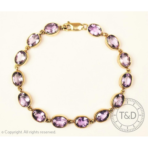 173 - An amethyst line bracelet set in 9ct gold, with lobster claw clasp stamped '375', gross weight 12.9g... 