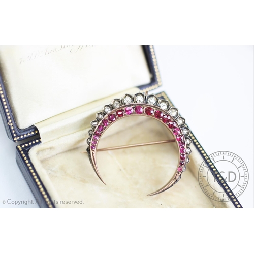 190 - A Victorian ruby and diamond crescent brooch, set throughout with graduated rubies and eighteen grad... 