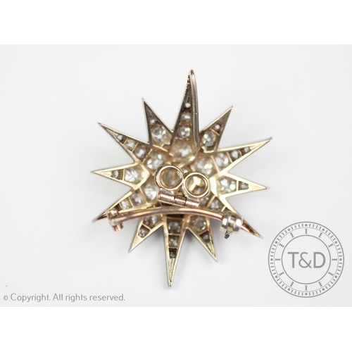 192 - A Victorian diamond set star brooch/pendant, originally from a tiara, the twelve point star, set thr... 