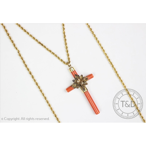 196 - A Victorian coral set cross pendant and chain, the coral set cross centred by a foliate spray with s... 