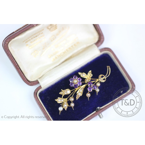 251 - A Victorian seed pearl and amethyst set spray brooch, set with nine claw set amethysts, and twenty-e... 