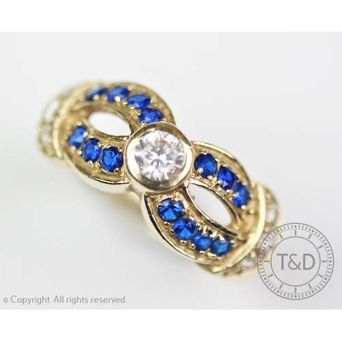 283 - An untested sapphire set dress ring, designed as a central collet set stone, within seven untested b... 