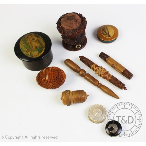 309 - A selection of carved sewing items, to include; a coquilla nut bobbin case, 7cm high, a carved wood ... 