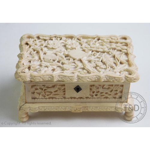 326 - An Indian carved ivory casket, circa 1890, the rectangular casket profusely carved with exotic birds... 