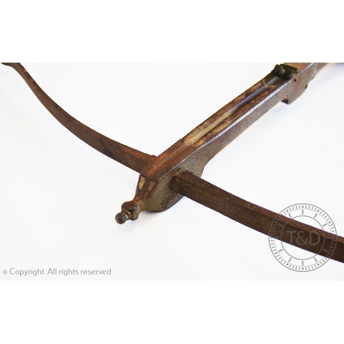 334 - An antique iron and hardwood crossbow, of typical 'T' form, lacking firing mechanism, 86cm long