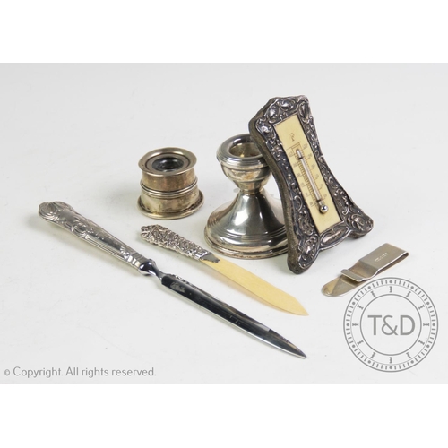 65 - A selection of silver and silver coloured items, to include; a silver candle stick, W I Broadway & C... 