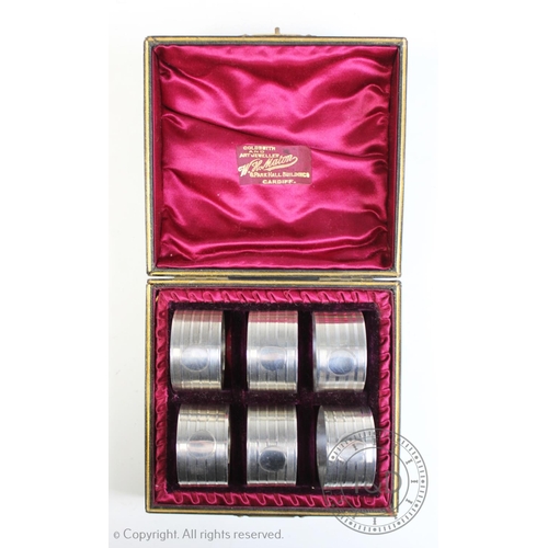 69 - A George V set of six silver napkin rings, Crisford & Norris Ltd, Birmingham 1935, each with vacant ... 