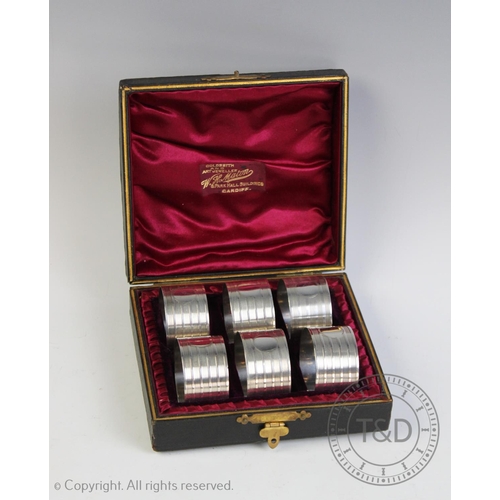 69 - A George V set of six silver napkin rings, Crisford & Norris Ltd, Birmingham 1935, each with vacant ... 