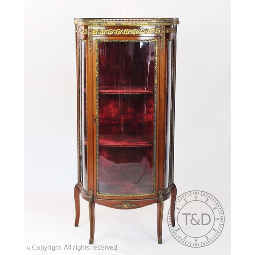 939 - A late 19th century French walnut vitrine, with pierced brass gallery embracing a rouge marble top, ... 