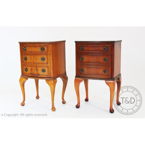 958 - A near pair of reproduction yew wood bedside chests, each with a frieze drawer, above hinged faux dr... 