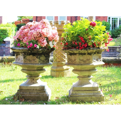 968 - A pair of reconstituted stone planters, of gothic font form on pedestal bases, 78cm H x 63cm W x 63c... 