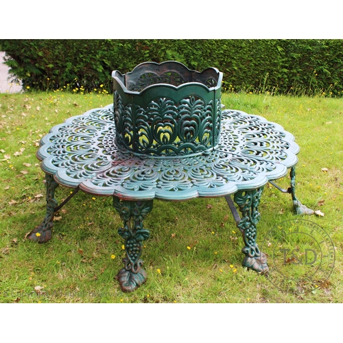 971 - A Victorian style cast iron, green painted tree seat of circular form, the seat and back decorated w... 