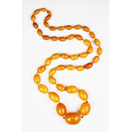 221 - A 'Butterscotch' amber single strand bead necklace, the forty-five graduated beads (largest measurin... 