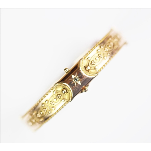 224 - A Victorian 9ct gold hinged bangle, Birmingham 1870, designed as a central claw set, old cut diamond... 