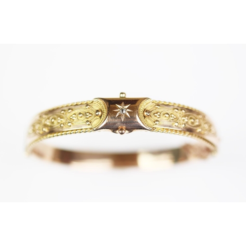 224 - A Victorian 9ct gold hinged bangle, Birmingham 1870, designed as a central claw set, old cut diamond... 