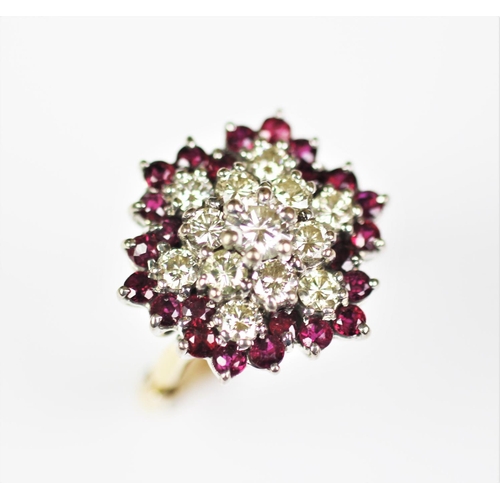 264 - A diamond and untested ruby cluster ring, the central diamond within a surround of six diamonds and ... 