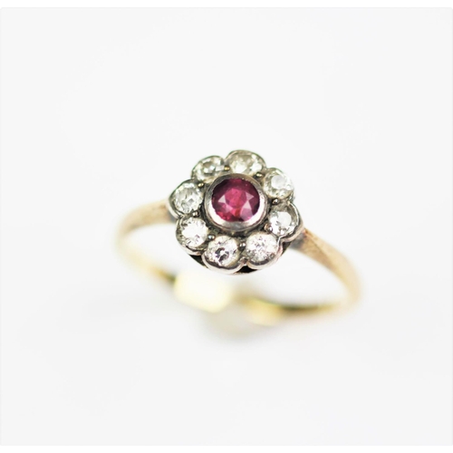 280 - An Edwardian ruby and diamond daisy cluster ring, designed as eight old cut diamonds enclosing a cen... 