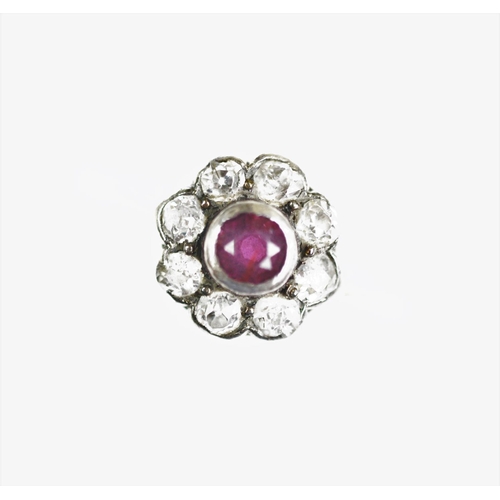 280 - An Edwardian ruby and diamond daisy cluster ring, designed as eight old cut diamonds enclosing a cen... 