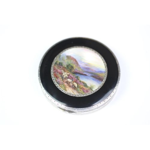 78 - An Art Deco enamelled compact, import mark for Stockwell & Co, London 1929, the circular compact fin... 