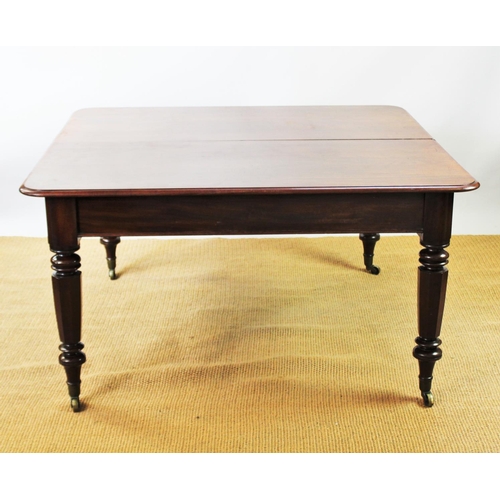 943 - A 19th century mahogany extending dining table, with turned octagonal legs and fitted brass castors,... 