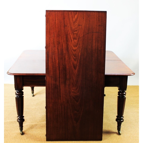 943 - A 19th century mahogany extending dining table, with turned octagonal legs and fitted brass castors,... 